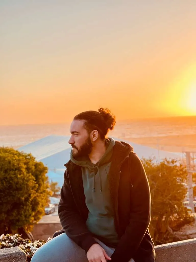 Nour by the ocean at sunset